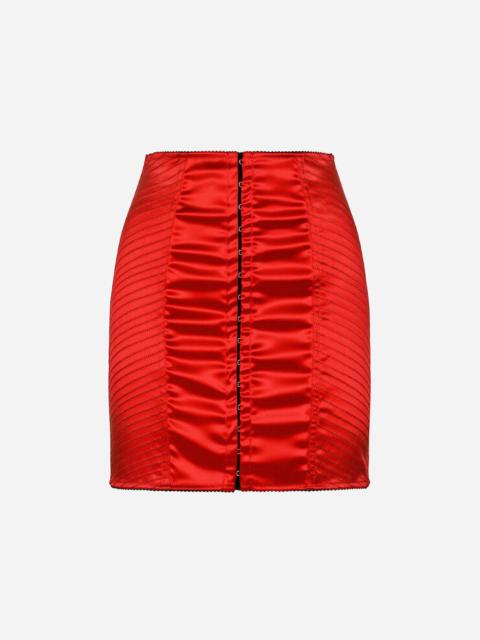 Satin miniskirt with hook-and-eye fastenings