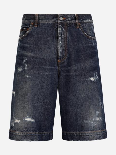 Blue denim shorts with abrasions