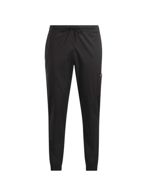 Reebok logo-patch tapered track trousers