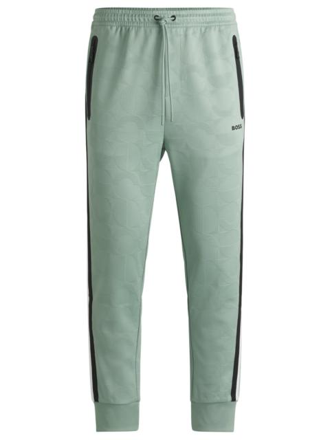 BOSS RELAXED-FIT TRACKSUIT BOTTOMS WITH JACQUARD-WOVEN CIRCLES
