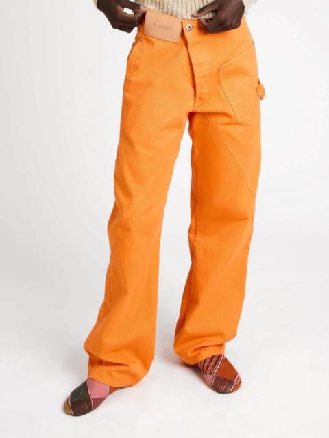 JW Anderson Bright orange twisted-denim jeans