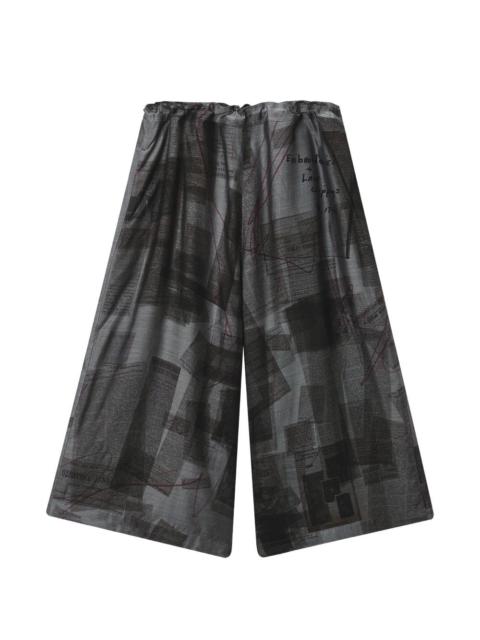 Y's newspaper-print wide-leg trousers