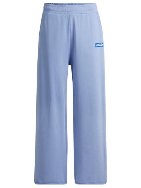 HUGO RELAXED-FIT TRACKSUIT BOTTOMS WITH LOGO PRINT
