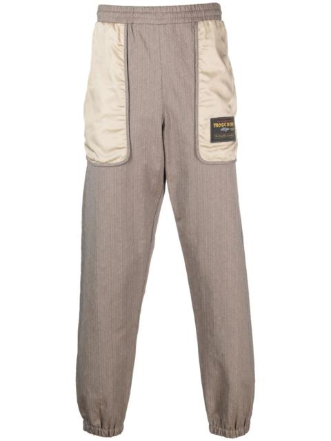 Moschino logo-patch panelled track pants