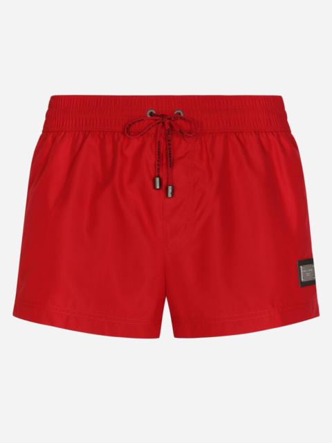 Short swim trunks with branded tag