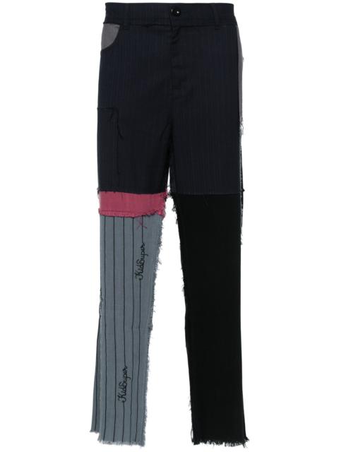 KidSuper patchwork distressed regular trousers
