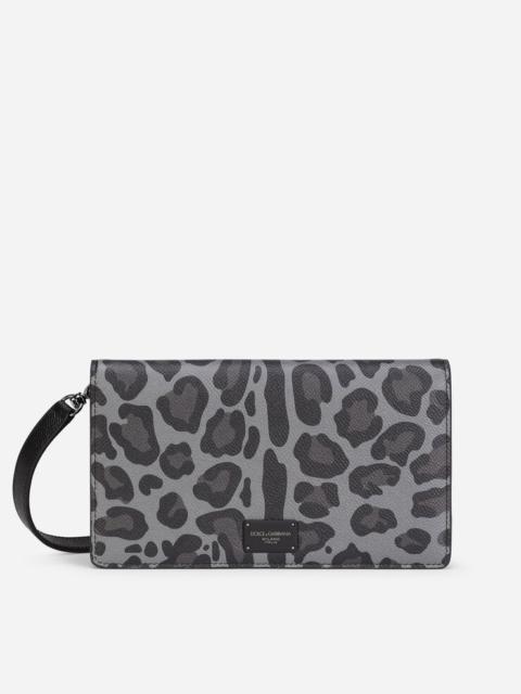 Dolce & Gabbana Dauphine calfskin wallet with shoulder strap and leopard print against a gray background