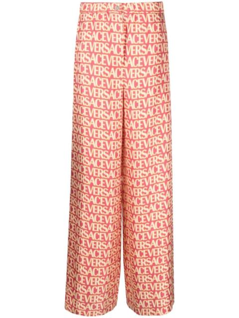 VERSACE logo-print silk palazzo pants