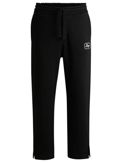 HUGO COTTON-TERRY TRACKSUIT BOTTOMS WITH EMBROIDERED GRAPHICS