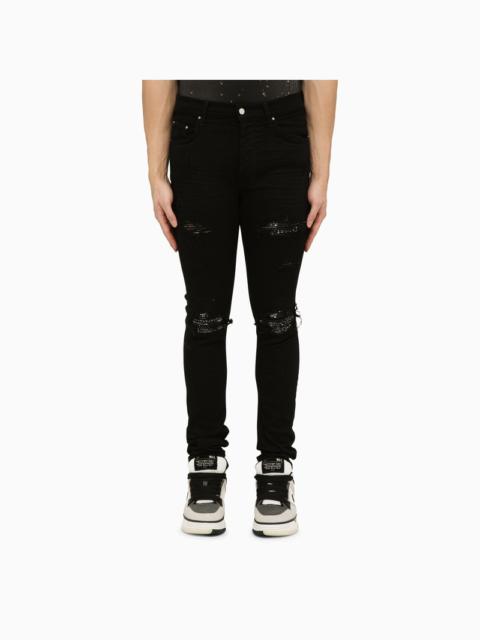 Black skinny jeans with camouflage patches