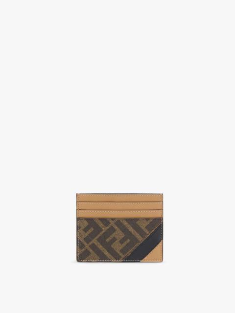 Card holder with six slots and flat central pocket. Made of textured fabric with FF motif in brown a