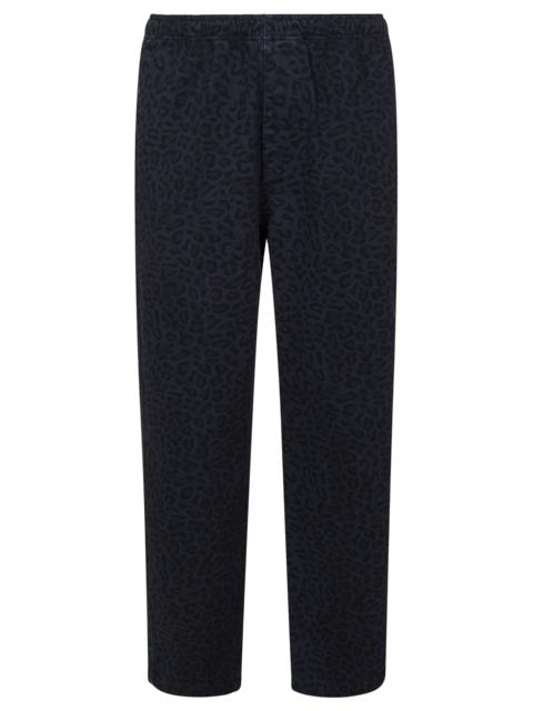 Stüssy Blue cotton trousers with all-over leopard print and elasticated waist.