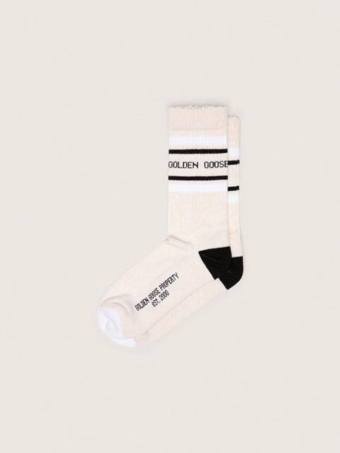 Golden Goose Blush-colored socks with distressed details and black and white stripes