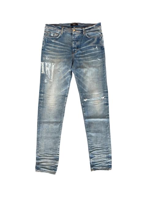 AMIRI Distressed Logo Jeans "Clay Indigo" PS23MDS007 408 CLAY