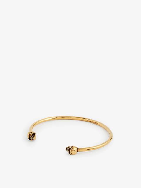 Skull-charm brass bangle