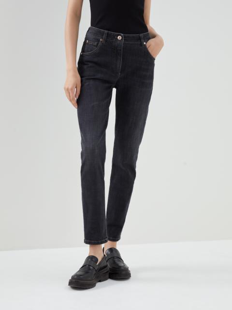 Stretch denim slim trousers with shiny leather tab