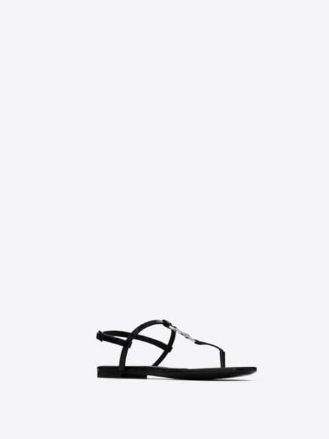 SAINT LAURENT cassandra flat sandals in patent leather with rhinestone monogram