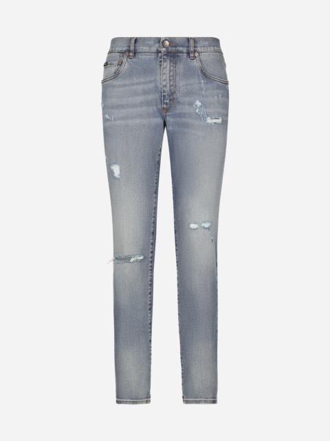 Slim-fit blue stretch denim jeans with abrasions