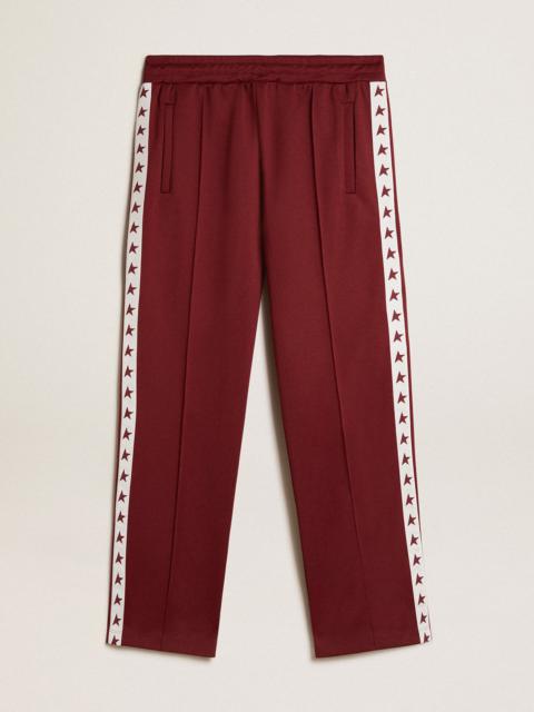 Golden Goose Men’s burgundy joggers with stars on the sides