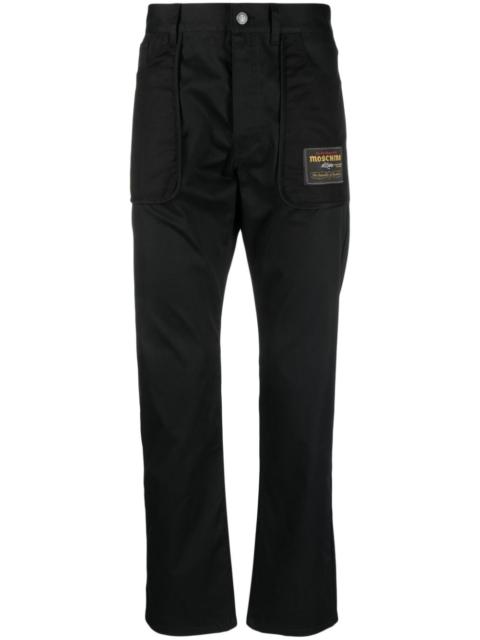 Moschino logo-patch straight-leg trousers