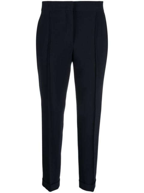 Moschino pressed-crease concealed-fastening tapered trousers