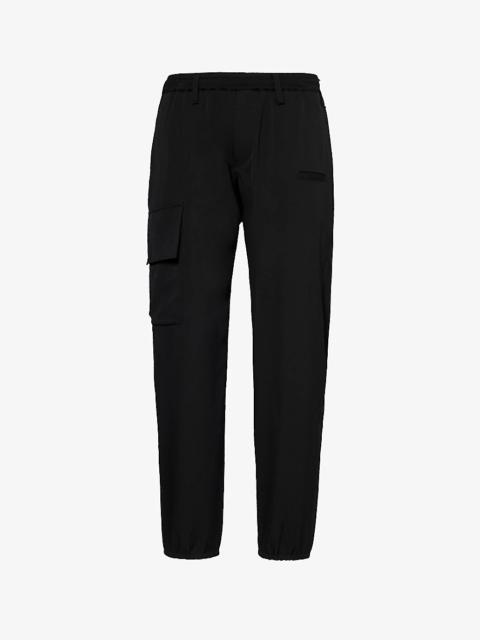 Flap-pocket mid-rise tapered-leg wool trousers