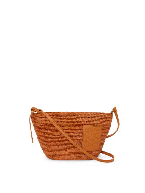 Slit Pochette bag in raffia and calfskin