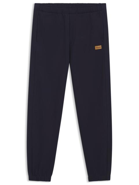 HUGO COTTON-TERRY SWEATPANTS WITH LOGO BADGE