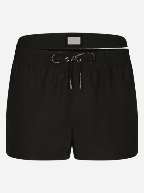 Short swim trunks with double waistband and branded tag