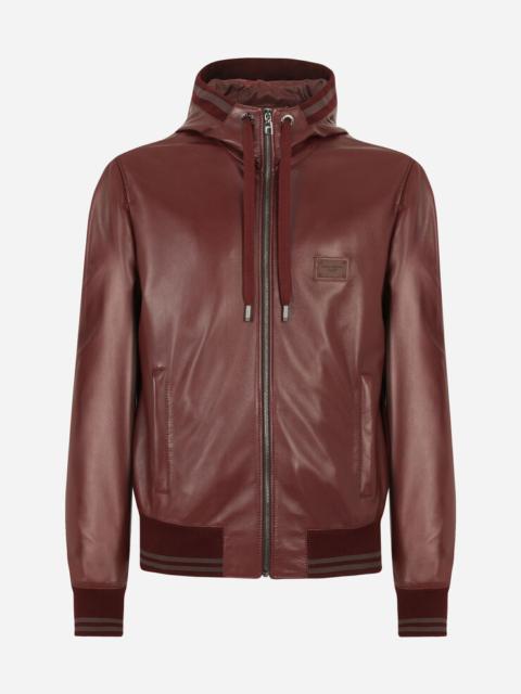 Leather jacket with hood and branded plate