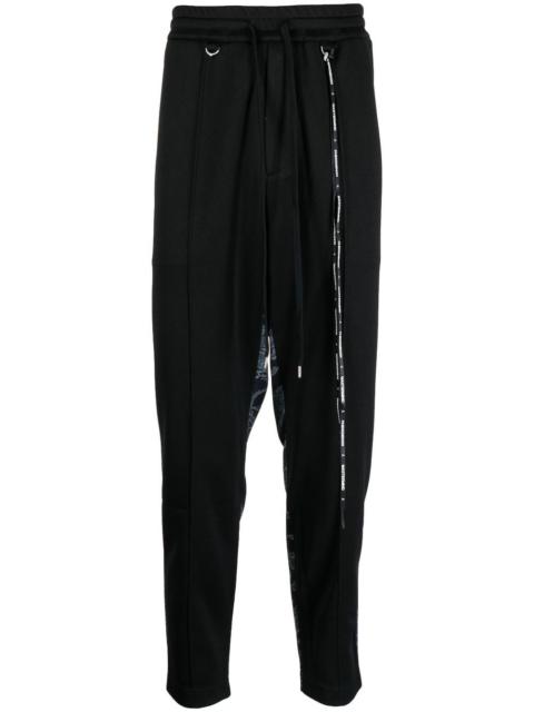 MASTERMIND WORLD camouflage-print track pants