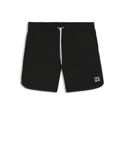 HUGO WAFFLE-STRUCTURED SWIM SHORTS WITH EMBROIDERED STACKED LOGO