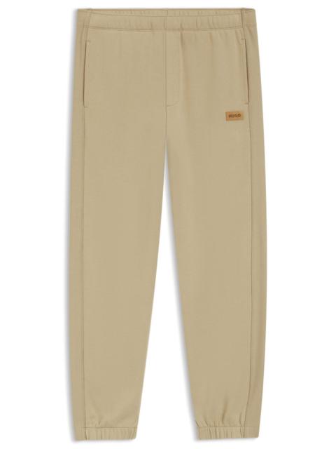 HUGO COTTON-TERRY SWEATPANTS WITH LOGO BADGE
