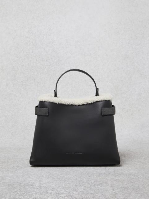 Brunello Cucinelli Matte calfskin bag with shearling trim and precious bands