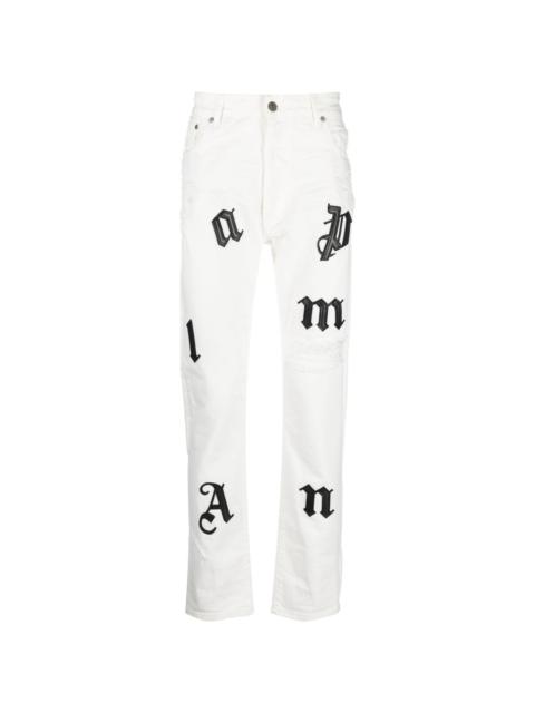 Palm Angels logo-patch distressed jeans