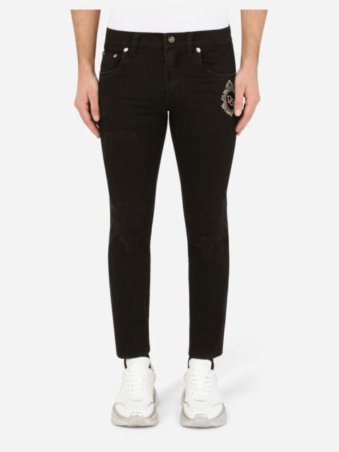 Dolce & Gabbana Black repaired skinny jeans with DG patch