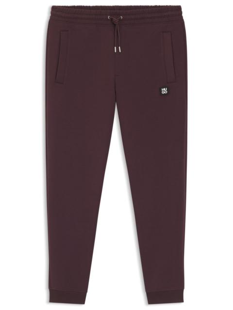 STACKED-LOGO TRACKSUIT BOTTOMS IN A COTTON BLEND