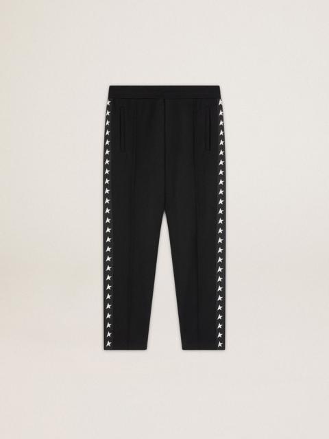 Men's black joggers with white stars on the sides