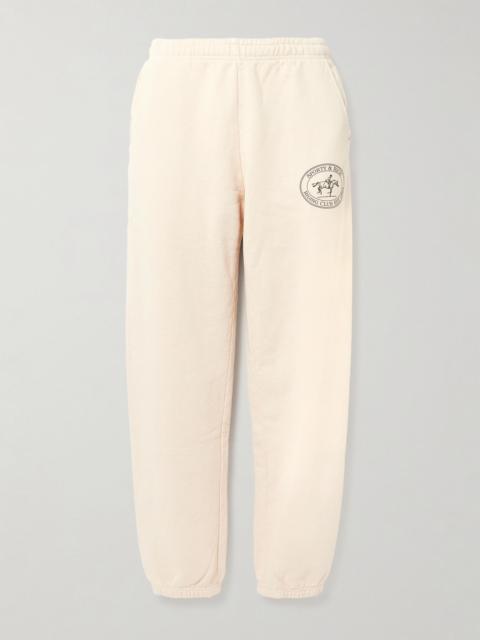 Sporty & Rich Riding Club printed cotton-jersey tapered sweatpants Cream