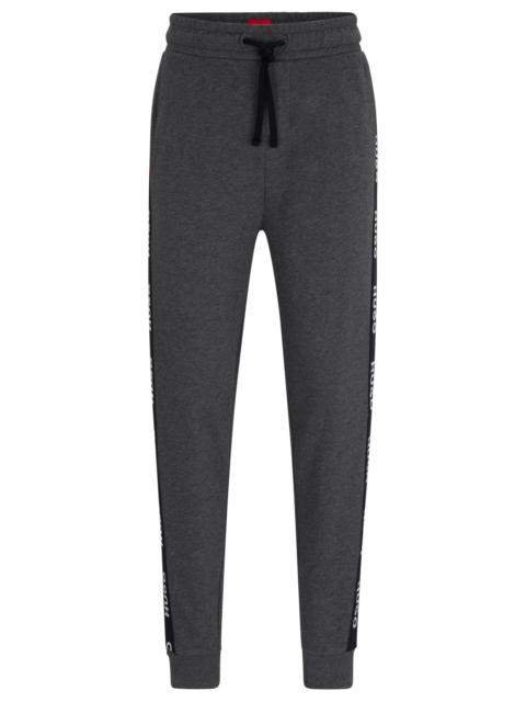 CUFFED TRACKSUIT BOTTOMS IN WITH LOGO TAPE