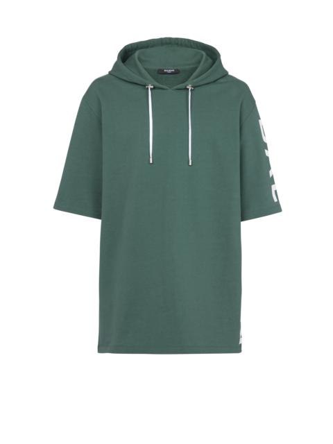 Oversized eco-designed cotton hooded sweatshirt with Balmain logo print