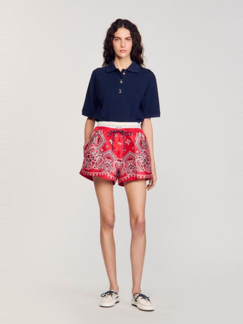 Sandro POLO SHIRT WITH DECORATIVE BUTTONS
