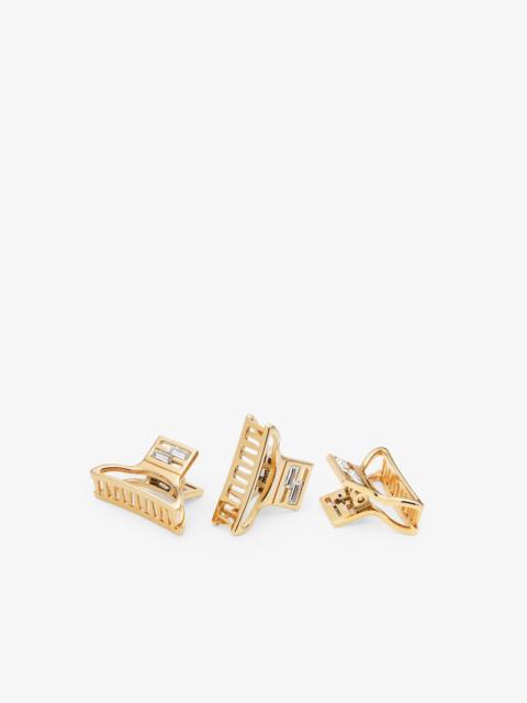 FENDI Set of three hair clips with FF Baguette motif. Made of metal with a gold finish. Decorated with Bag