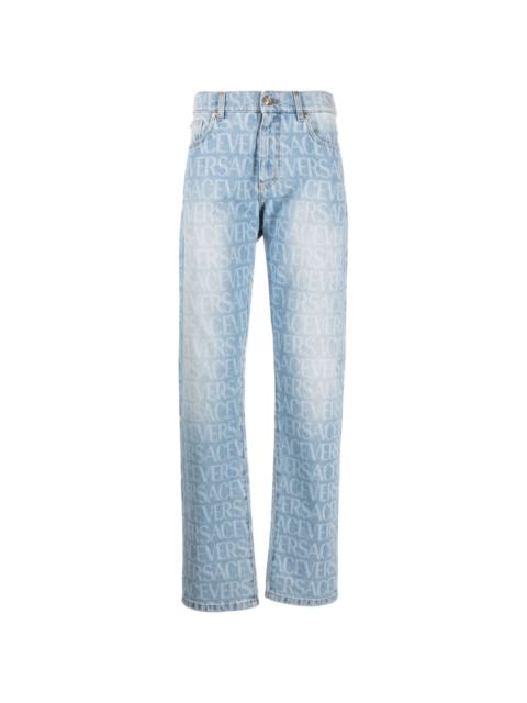 VERSACE Allover logo-print jeans