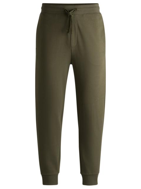 HUGO COTTON-TERRY TRACKSUIT BOTTOMS WITH LOGO PRINT