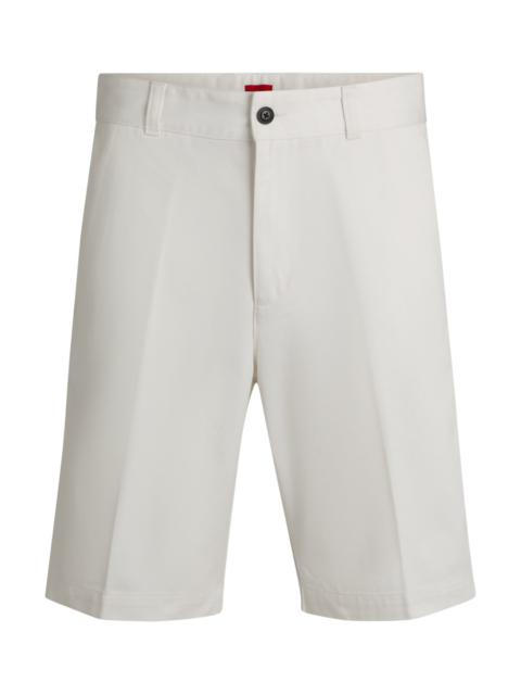 HUGO REGULAR-FIT SHORTS WITH SLIM LEG AND BUTTONED POCKETS