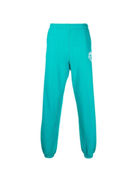 Sporty & Rich crest logo print track pants