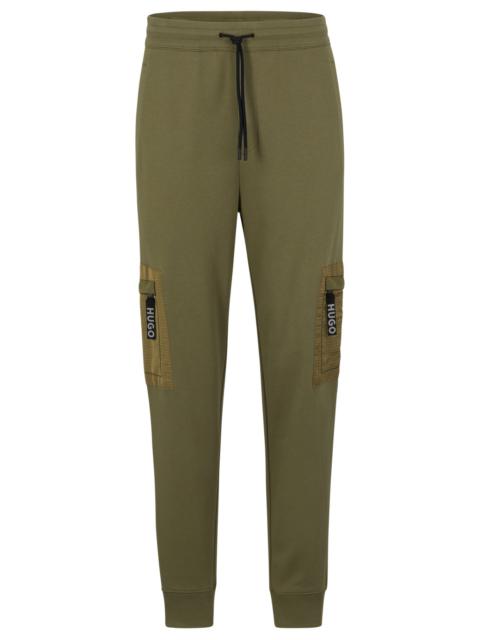 HUGO RELAXED-FIT TRACKSUIT BOTTOMS WITH CARGO POCKETS