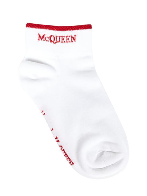 White ankle socks in cotton blend with red McQueen logo inlaid on the sides.