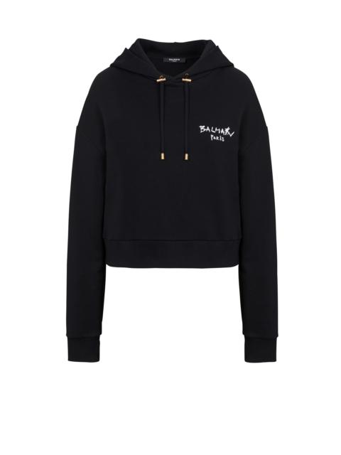 Balmain Cropped eco-design cotton sweatshirt with flocked graffiti Balmain logo